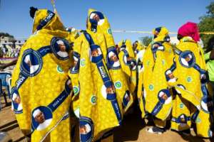 Among goodies being handed out to prospective voters is colourful fabric displaying the face of the Chadian president.  By Joris Bolomey (AFP)