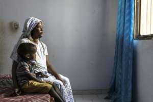 Amy Drame continues to tell her children that their father is away fishing despite his death.  By PATRICK MEINHARDT (AFP)