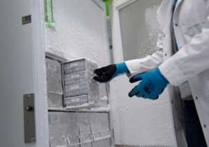 An employee opens an ultra-low-temperature freezer where Covid-19 vaccines will be stored in the Spanish Basque city of Hernani.  By ANDER GILLENEA (AFP/File)