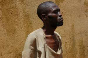 An inmate at Kenema jail takes his turn in the prison courtyard.  By Saidu BAH (AFP)