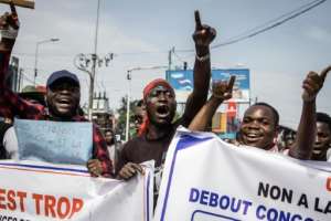 Anti-Rwanda protesters in Goma march towards the border last October.  By MICHEL LUNANGA (AFP)