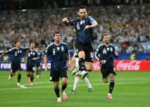 Argentina forward Lionel Messi celebrates scoring his teams third goal during a 3-1 win over Jordan.  By Paul ELLIS (AFP)