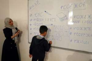 Assirem Shawashi (L) says its not just about the alphabet and vocabulary, but a whole culture.  By Mahmud Turkia (AFP)