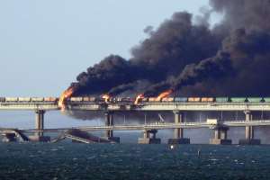 Black smoke billows from a fire on the Kerch bridge that links Crimea to Russia, after a truck exploded, near Kerch, on October 8, 2022.  By - (AFP/File)