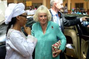 Britains Camilla (C), Duchess of Cornwall, and Fatou Bah-Barrow (L), wife of Gambias President Adama Barrow, visited a local school.  By LUC GNAGO (POOL/AFP)