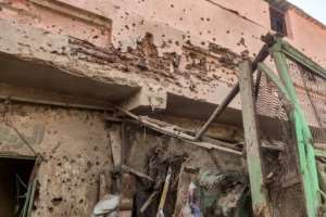 Bullet holes riddle the wall of a building at Khartoums Market Six where 18 civilians were killed in a bombardment by the regular army on Wednesday.  By - (AFP)