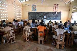 Children of cocoa producers studying in a classroom without electricity.  By Sia KAMBOU (AFP)