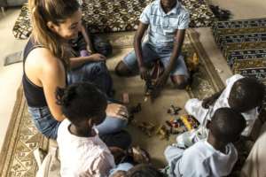 Children who have lost family members to migration at sea participate in a psychosocial support session at the DDM offices in Mbour.  By PATRICK MEINHARDT (AFP)