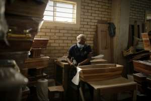 Coffins have been in high demand due to the rising deaths, with producers struggling to build fast enough.  By Guillem Sartorio (AFP)