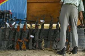 Confiscated weapons were displayed at the first hearing in the coup trial.  By Arsene MPIANA (AFP)