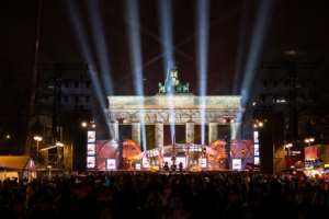 Crowds gathered early in front of a stage erected in front of Berlins landmark the Brandenburg Gate, ahead of a New Years party.  By Monika Skolimowska (dpa/AFP)