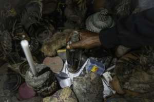 Dauda Tshimanga holds a bottle of traditional medicine in his workshop in Bunia.  By Glody MURHABAZI (AFP)