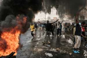 Demonstrators set fire to tyres in the Nairobi slum of Kibera.  By YASUYOSHI CHIBA (AFP)