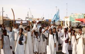 Demonstrators unhappy with parts of a 2020 peace deal with ethnic minority rebels gather outside the docks in Port Sudan on Monday, one of a string of protests against the transitional governments policies in recent months.  By Ibrahim ISHAQ (AFP)