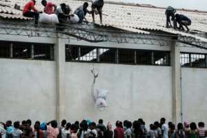 Desperation: Sacks of Chinese rice aid were looted from a warehouse in Beira on Wednesday.  By Yasuyoshi CHIBA (AFP)