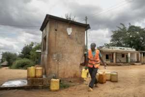 Dominic Mwakai, 43, sells water collected from natural springs flowing from Mount Kasigau.  By Tony KARUMBA (AFP)