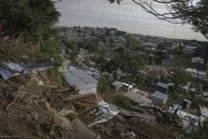 Dozens of shacks vanished in seconds when the ground, over-saturated with flood water -- crumbled at Durbans informal settlement of eNkanini.  By Guillem SARTORIO (AFP)