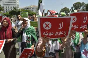 During a Hirak demonstration last year, protesters carried placards saying in Arabic No to biased media.  By RYAD KRAMDI (AFP/File)