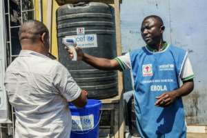 Ebola guidelines include checking temperatures and washing hands.  By Pamela TULIZO (AFP/File)