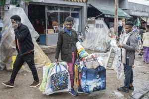 Economists argue the reform will bring short-term pain but long-term benefits.  By Amanuel Sileshi (AFP)