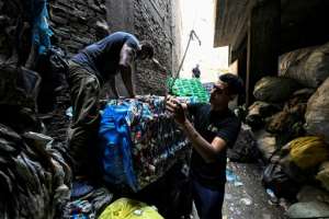 Egyptian families live and work in spaces barely separated from mountains of waste.  By Khaled DESOUKI (AFP)