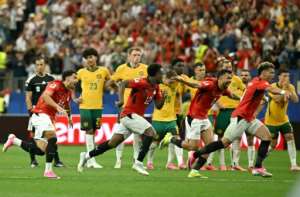 Egypts players celebrate after their penalty shoot-out victory over Australia.  By Paul ELLIS (AFP)