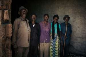 Elderly workers employed by the JTN plantation pose for a picture in the courtyard of the factory. By ALEXIS HUGUET (AFP/File)