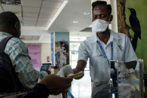Entebbe airport health workers checked travel documents of passengers arriving on an international flights.  By SUMY SADURNI (AFP)