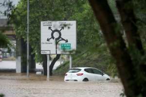 Entire streets in Frances La Reunion were inundated and cars washed away.  By Richard BOUHET (AFP)