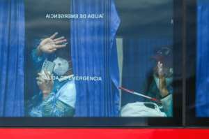 Evacuees boarded Spanish army buses and travelled to Tenerife South airport before changing protective equipement and boarding repatriation flights.  By JORGE GUERRERO (AFP)