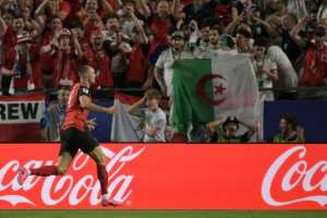 Fans react as Austria forward Sasa Kalajdzic celebrates scoring the header that sent his team into the World Cups last 32.  By JUAN MABROMATA (AFP)