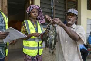 Fishermen have their catch weighed as part of data-driven conservation efforts.  By Tony KARUMBA (AFP)