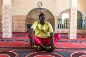 For imam Kalipha Dampha, blocking FGM blocks is an assault on religious freedom.  By MUHAMADOU BITTAYE (AFP)