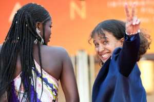 French actress and film director Mati Diop (R) flashes the victory sign as she arrives with Senegalese actress Mama Sane for the screening of the film Atlantics (Atlantique) at the 72nd edition of the Cannes Film Festival.  By CHRISTOPHE SIMON (AFP)