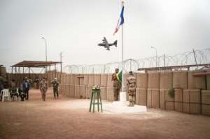 French forces prepare to lower the tricolore flag at the Timbuktu base on December 14, handing the facility to the Malian army.  By FLORENT VERGNES (AFP)