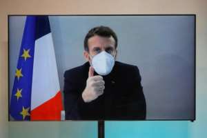 French President Emmanuel Macron, who tested positive for the coronavirus, is in stable condition and continuing with his duties.  By CHARLES PLATIAU (POOL/AFP)