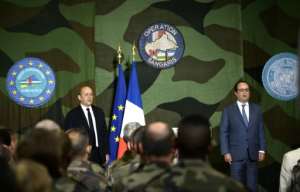 French President Francois Hollande R) said French troops would remain in Central African Republic as long as necessary, but Operation Sangaris was not designed to last