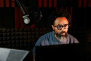 Ghirmaile records a programme in the studio of Radio Erena in Paris.  By Gregoire CAMPIONE (AFP)