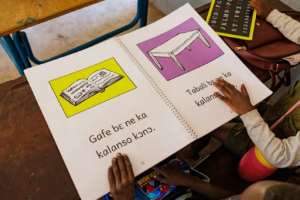 Girls using a book to learn Bambara, one of Mali€s national languages.  By - (AFP)