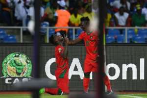 Guinea-Bissaus defender Juary Soares (L) celebrates with teammate Aldair after scoring a late equalizer against Gabon in Libreville on January 14, 2017