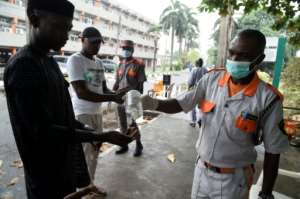 Hand hygiene: A visitor uses sanitisation gel before being allowed into a state hospital in Lagos. By PIUS UTOMI EKPEI (AFP)