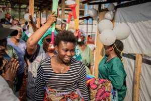 Healthcare workers celebrate with Ebola survivors leaving a medical centre in Ituri after being confirmed cured.  By Benediction MURHABAZI (AFP)