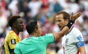 Honduran referee Said Martinez speaks with England captain Harry Kane and Ghana defender Marvin Senaya during the 0-0 draw in Foxborough.  By FRANCK FIFE (AFP)