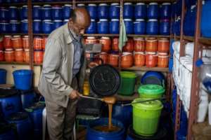 Honey seller Birhanu Araya says he has less to sell at his shop as the war affected bees.  By Michele Spatari (AFP)