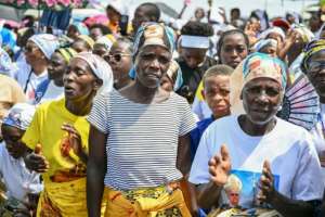 Hundreds of faithfuls hundreds, dressed in colourful outfits lined the road singing as he arrived.  By Alberto PIZZOLI (AFP)