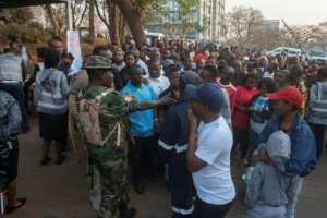 Hundreds of voters gathered outside pollings stations for a chance to choose their next president and parliament.  By Amos GUMULIRA (AFP)