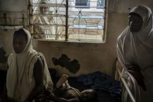 Husaina Saidu (L) survived the attack.  By CRISTINA ALDEHUELA (AFP)