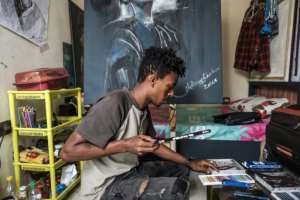 In Asmara, Nebay had an apartment and a separate studio, but these days he works out of his cramped living space on the outskirts of Addis.  By EDUARDO SOTERAS (AFP)