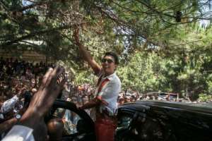 Incumbent Madagascar President Andry Rajoelina, greets supporters at the first meeting of his election campaign.  By RIJASOLO (AFP)