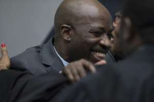 Joy: Charles Ble Goude hugs his lawyers at the ICC.  By Peter Dejong (ANP/AFP)